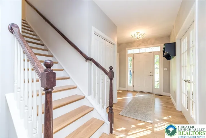 Foyer with hardwood floors and coat closet