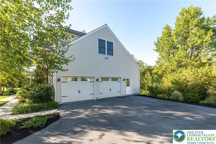 Oversized 2 car garage with door to storage area