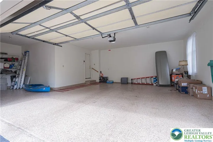 Garage has storage area, epoxy floor