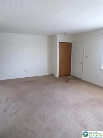 side view of living room to show coat closet