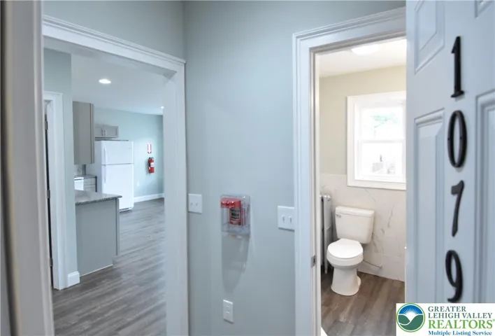 Entering the front door, 1st full bathrm to right and kitchen/livining rm to the left...