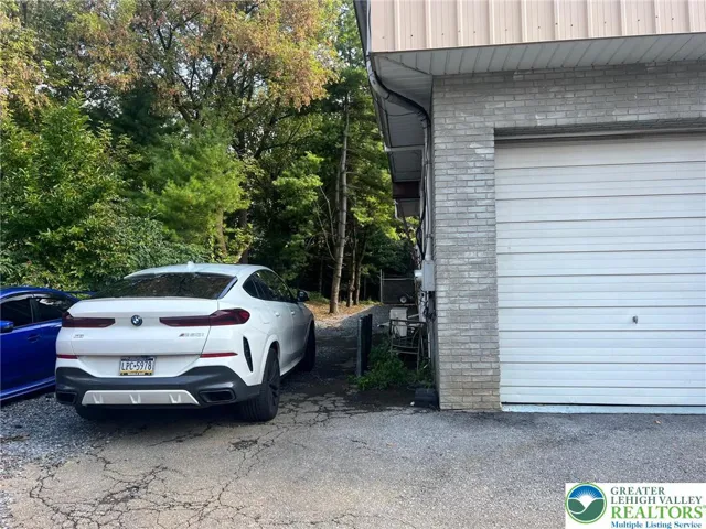 parking to the side of the warehouse door. Warehouse is rented. There may be one storage unit available for rent.