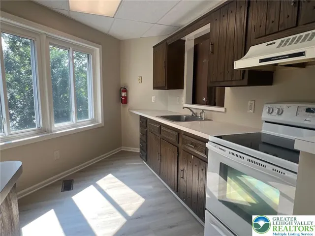 Kitchen overlooks warehouse parking lot