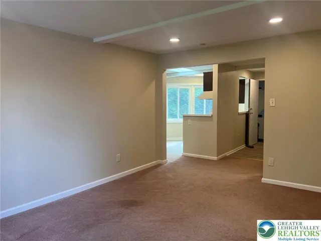 Living room view to kitchen and hall