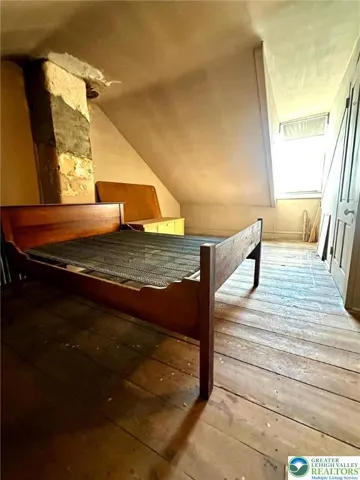 Attic bedroom with radiator heat, large closet & wide plank flooring