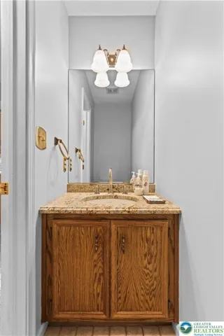 A main floor Powder Room is descreetly tucked between the DR & Kitchen