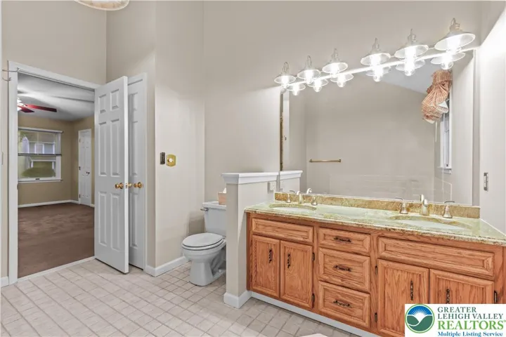 Enter the Master Bath w/ Tiled Floors, Vaulted Ceiling & Skylight