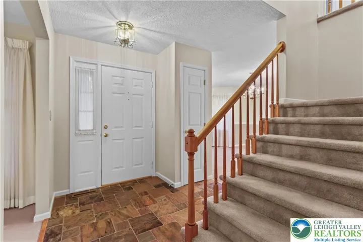 Enter through the Front Door into a Brazilian Slated Foyer