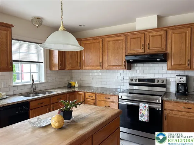 Kitchen with butcher block island and granite everywhere else