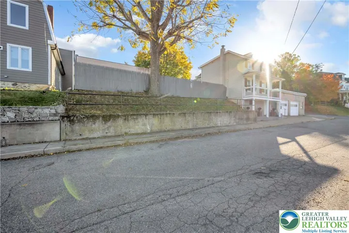 The adjacent home to the right of the lot is for sale also.