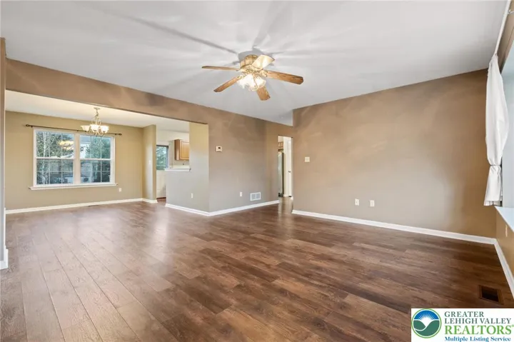 Ceiling fan and a flow to the dining room and main hallway
