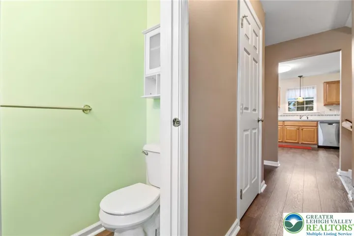 Powder room is down the hall, near the stairs going up to the bedroom level