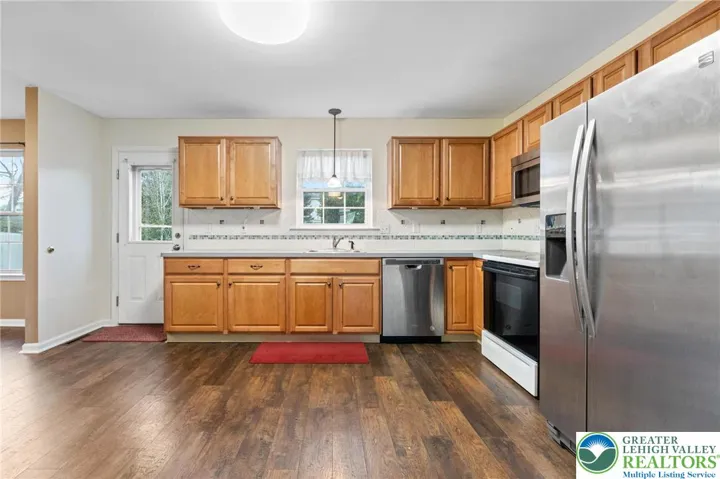 Stainless appliances and the door leads you to the back deck