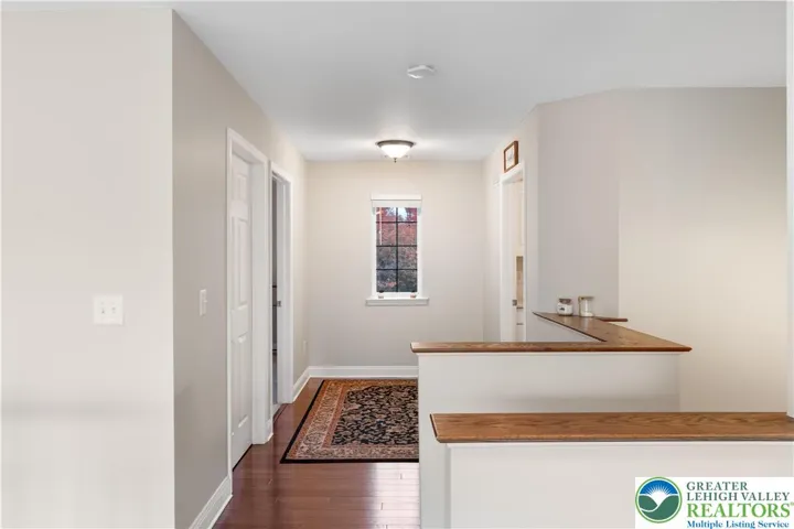 Upstairs hallway leads to a bedroom, laundry room and large storage closet.