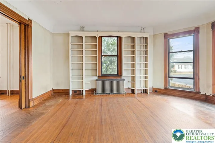 Original woodwork, original hardwood floors, built in bookshelves
