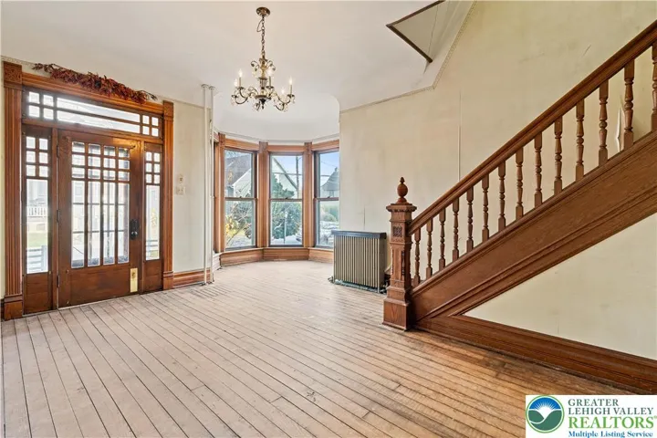 Original hardwood floors, tall 9 foot ceilings, original wood pocket doors, original woodwork, big windows