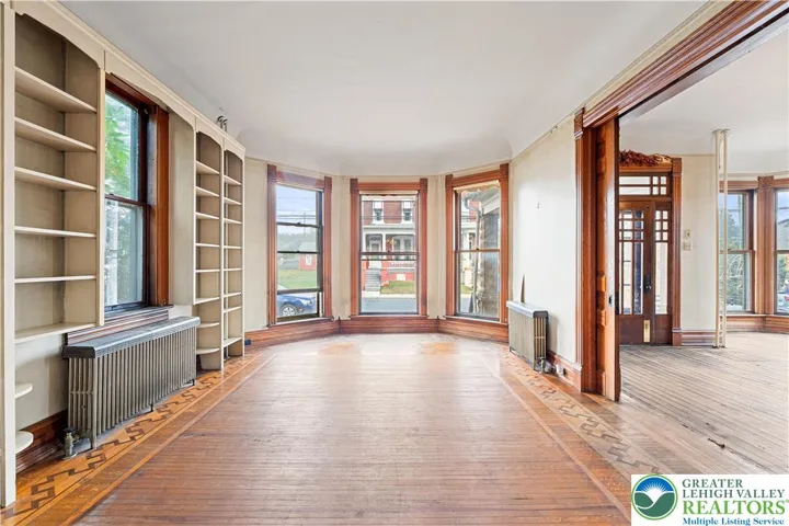 Original woodwork, original hardwood floors, built in bookshelves