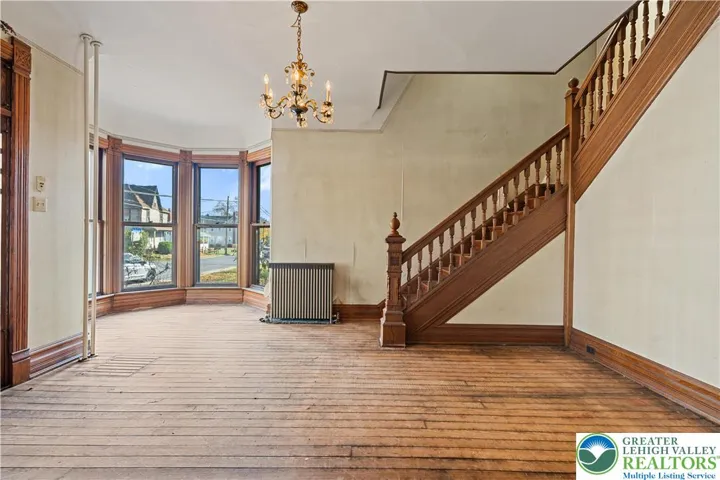 Original hardwood floors, tall 9 foot ceilings, original wood pocket doors, original woodwork, big windows
