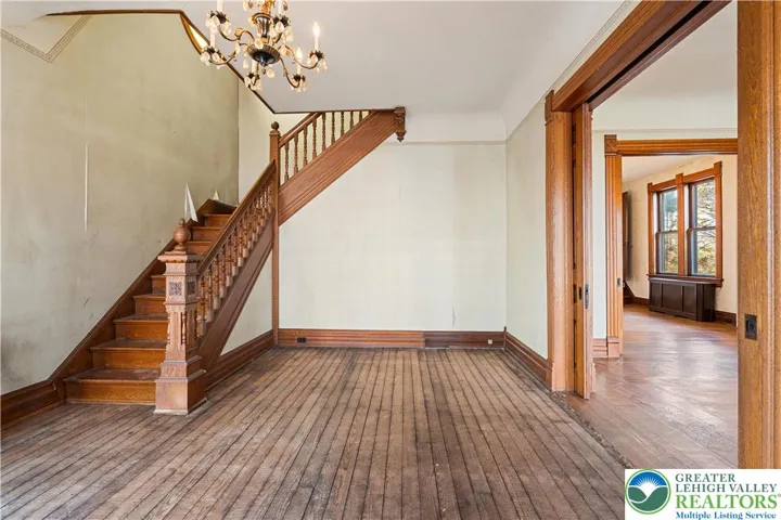 Original hardwood floors, tall 9 foot ceilings, original wood pocket doors, original woodwork