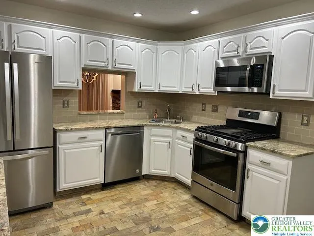 Updated kitchen with granite counters and stainless appliance package