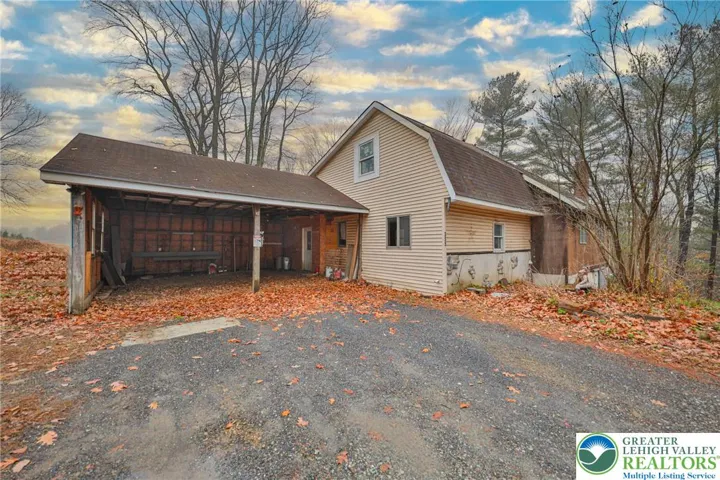 Front of home with 2 car covered parking