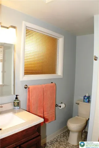 Note updated fixtures and a shared smoked glass window with the hall bathroom