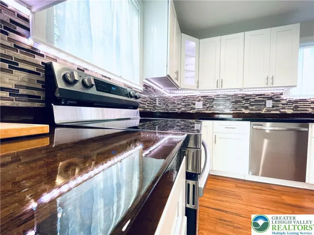 A custom epoxy-polished countertop features motion-sensing under-lighting that adds dramatic ambiance and contemporary sophistication.