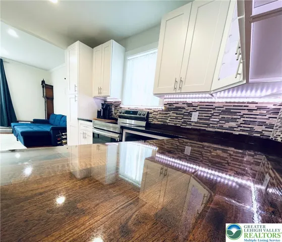 A custom epoxy-polished countertop features motion-sensing under-lighting that adds dramatic ambiance and contemporary sophistication.