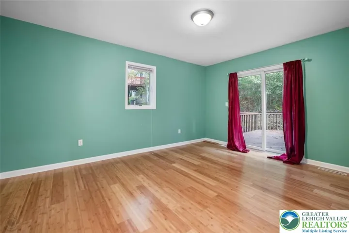 1st floor master bedroom with ensuite bath and sliding door to the deck