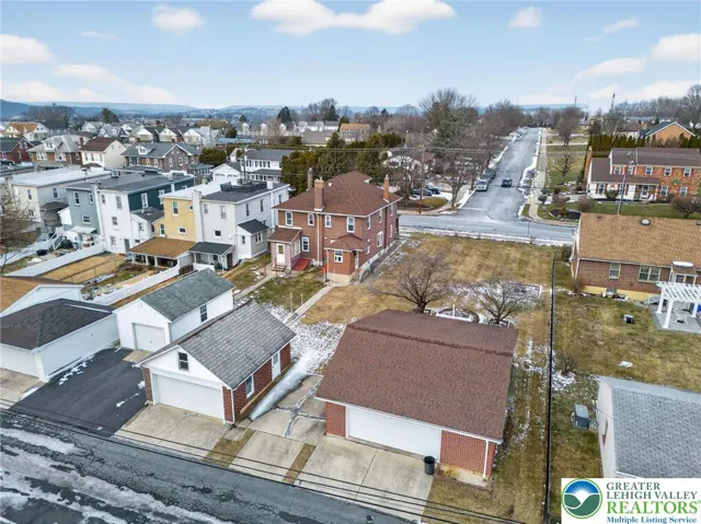 Two detached garages with additional parking pad