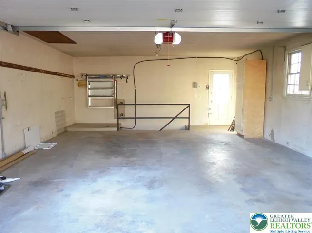 Fully Insulated Garage W/ Walk Up Attic Storage & Staircase To Lower Level