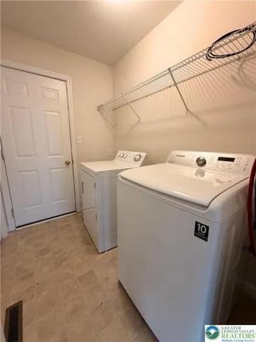 Main-level laundry and utility room with additional storage.