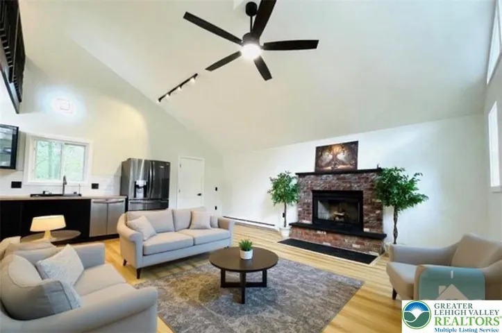 Open floor concept, wood fire place, virtually staged living room.