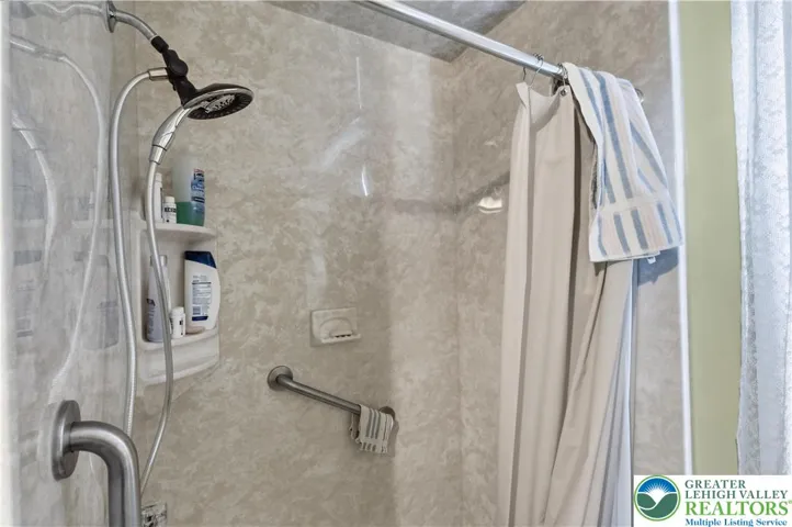 Standing shower in bedroom adjacent to full bathroom
