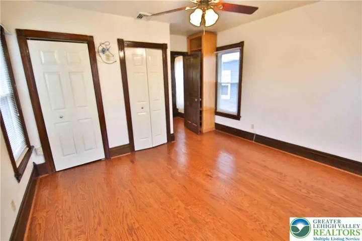 Front bedroom w/2 closets and additional storage behind the door