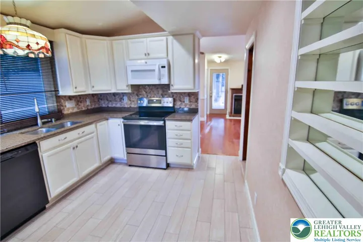 Updated kitchen with granite counters, lots of storage space and room to food prep!