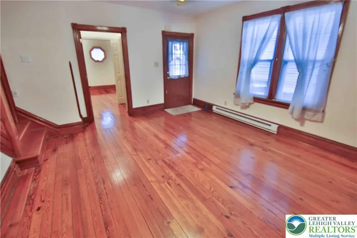 Original pinewood floors greet you in the living room