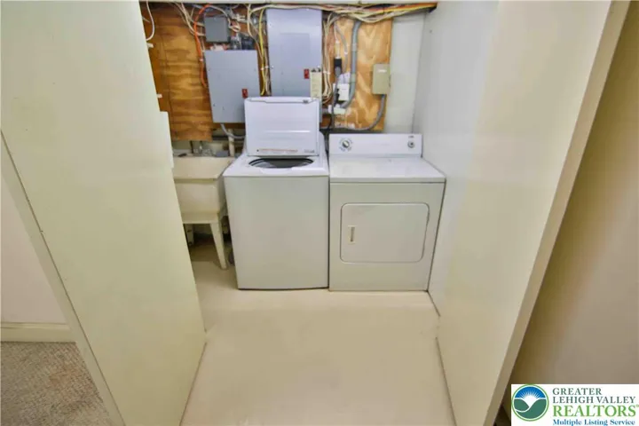 Laundry area with automatic light and doors to tuck it away when not in use