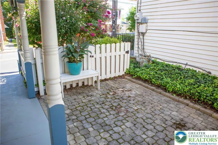 Paver patio along the side of the covered porch