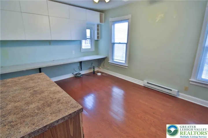 Middle bedroom previously used as an office; keep the built-ins for storage or remove - either way it's a great size room
