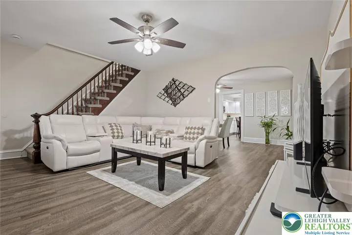 Living room with luxury vinyl plank flooring and clean, modern finishes