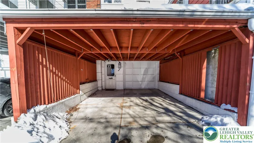 Covered rear entry and carport PLUS 1 car garage with storage shelves
