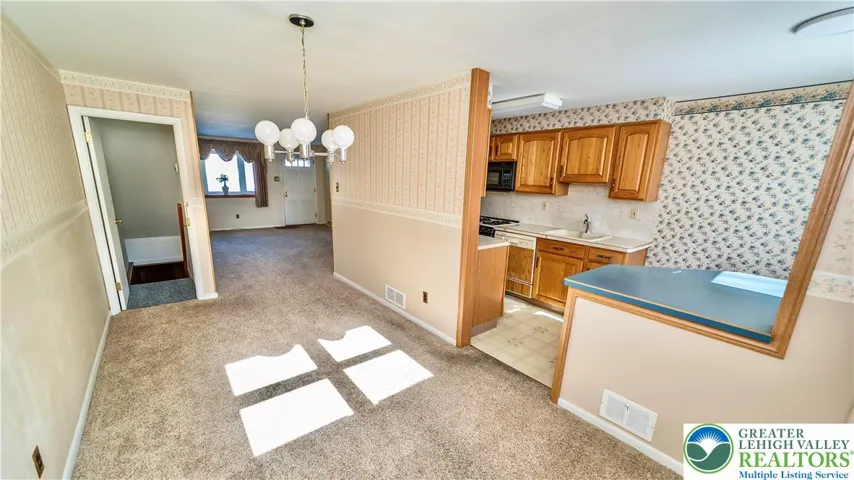 Dining room (hardwood is believed to be underneath carpet)