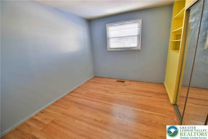 Bedroom #1 with large closet & wood flooring