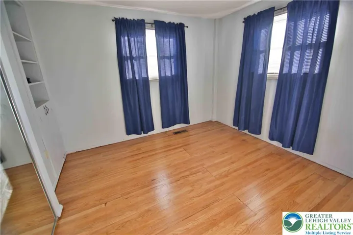 Bedroom #3 with wood floors and mirrored closet doors