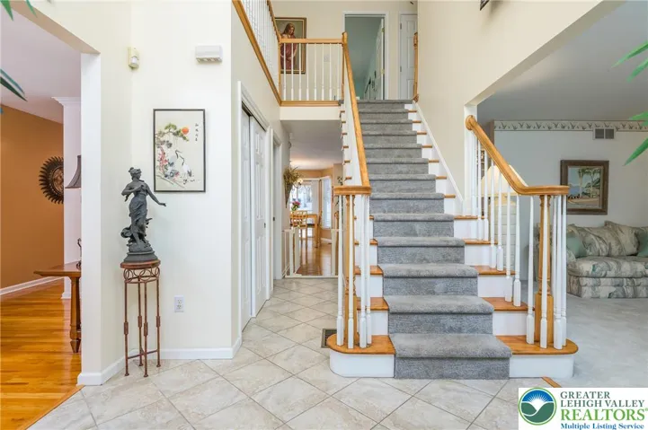 Wide foyer and graceful staircase to the second floor.