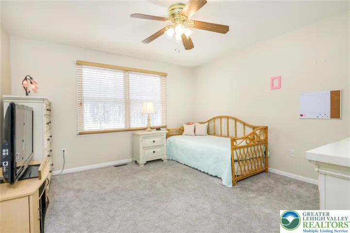 Bedroom #4.  Newer carpet.  Ceiling fan.
