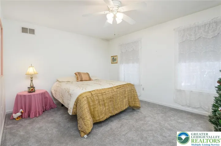 Bedroom #2.  Newer carpeting.  Ceiling fan.