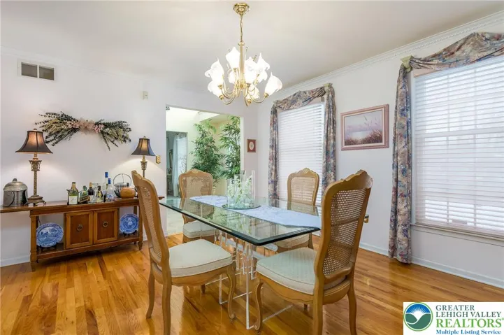 The spacious formal dining room with original hardwood floors in wonderful condition.