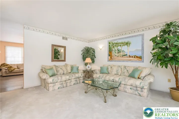 Formal living room opens to the family room.